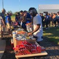 football players lined up to get food